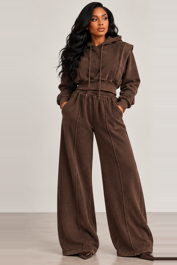 Front view of a model wearing the brown Laid-Back Luxe Set with a cropped drawstring hoodie and wide-leg pants with exposed seams.