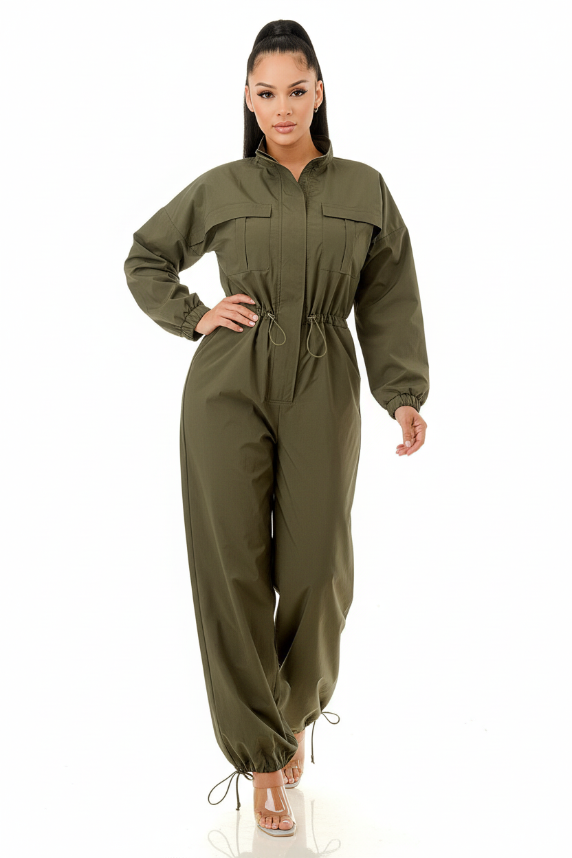 White model wearing olive green utility jumpsuit